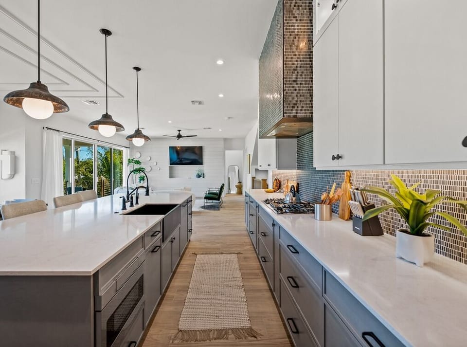 Picture yourself creating memorable meals in this stunning chef's kitchen. Gleaming countertops, high-end appliances, and a spacious island invite you to cook, gather, and entertain in style and comfort.