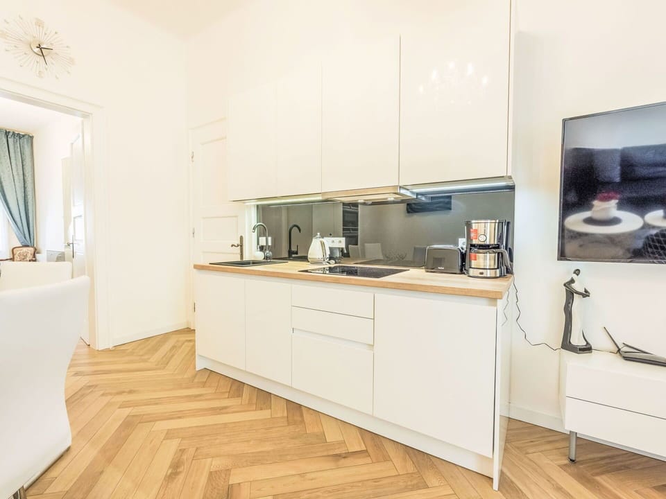 Flooring, Interior Design, Kitchen Appliance, Kitchen, Countertop, Floor, Wood, Cabinetry, Furniture, Major Appliance