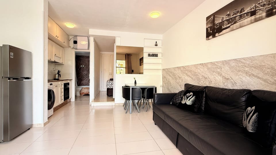 Apartment, Balcony, Garden View | Living area | 50-inch flat-screen TV with digital channels