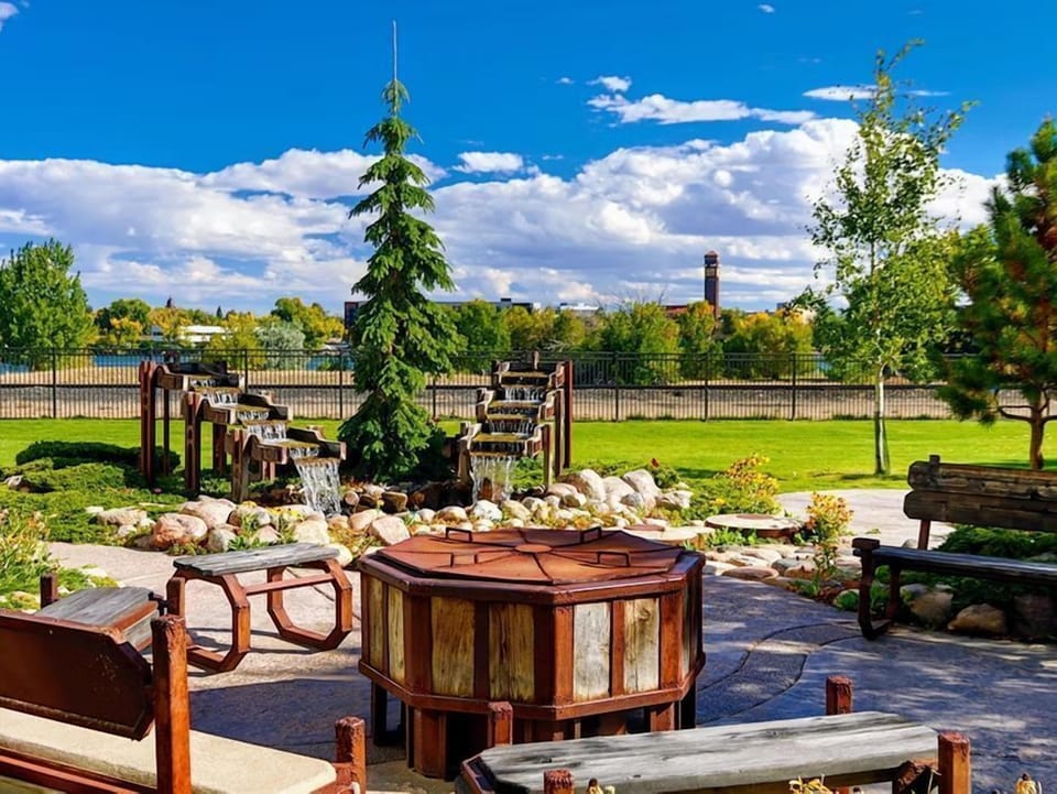 Relax by the bubbling streams and lush greenery in this serene outdoor space.