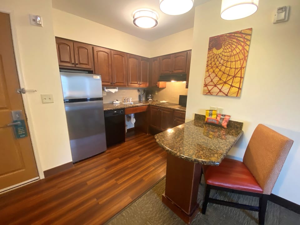Experience home cooking in this well-equipped kitchen featuring modern appliances and a warm atmosphere.
