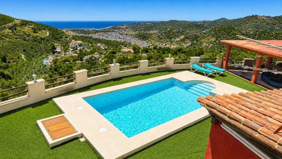 A beautiful hillside villa pool with sweeping views of the valley and sea.
