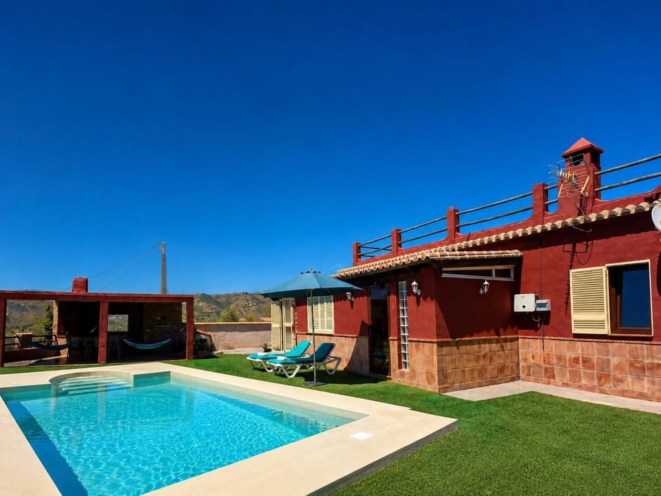 A beautiful villa with a private pool and sunny outdoor relaxation area.
