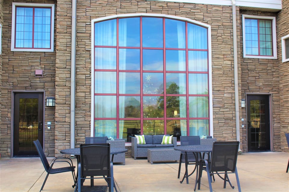 Outdoor seating area with comfortable furniture and greenery.