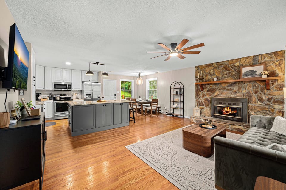 Living Room: Warm up by the stone fireplace and enjoy modern comforts in this inviting space!

