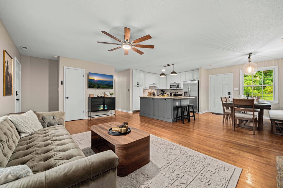 Living Room & Kitchen: Bright, open space with modern decor and a view of nature awaits you!