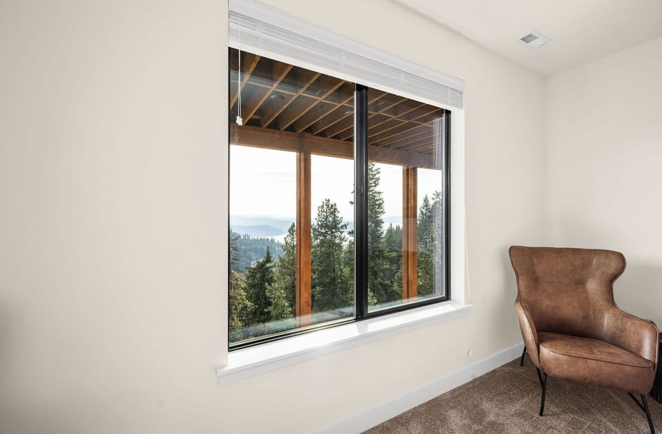 Settle into your reading nook with stunning mountain views framed by towering pines—a peaceful corner where you can unwind and soak in the natural beauty.