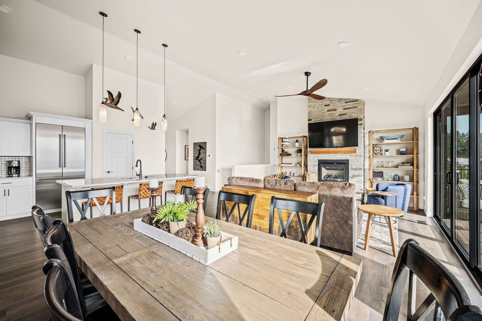 Gather around this spacious dining table where your group can share meals under charming pendant lights. The open layout connects you to the cozy living area and bright windows.