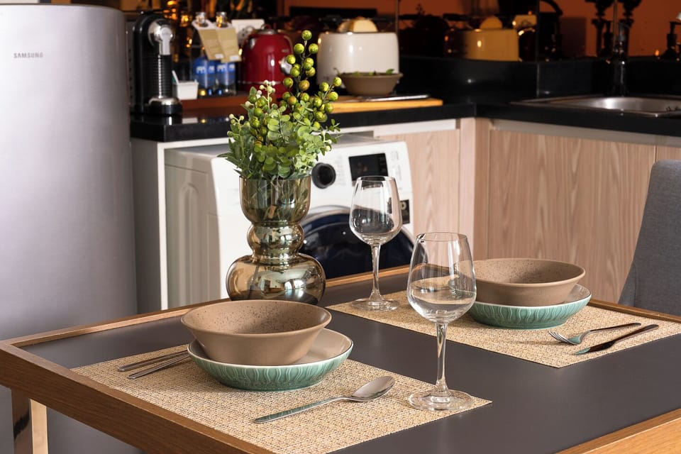Cozy dining nook for two beside a fully equipped modern kitchenette