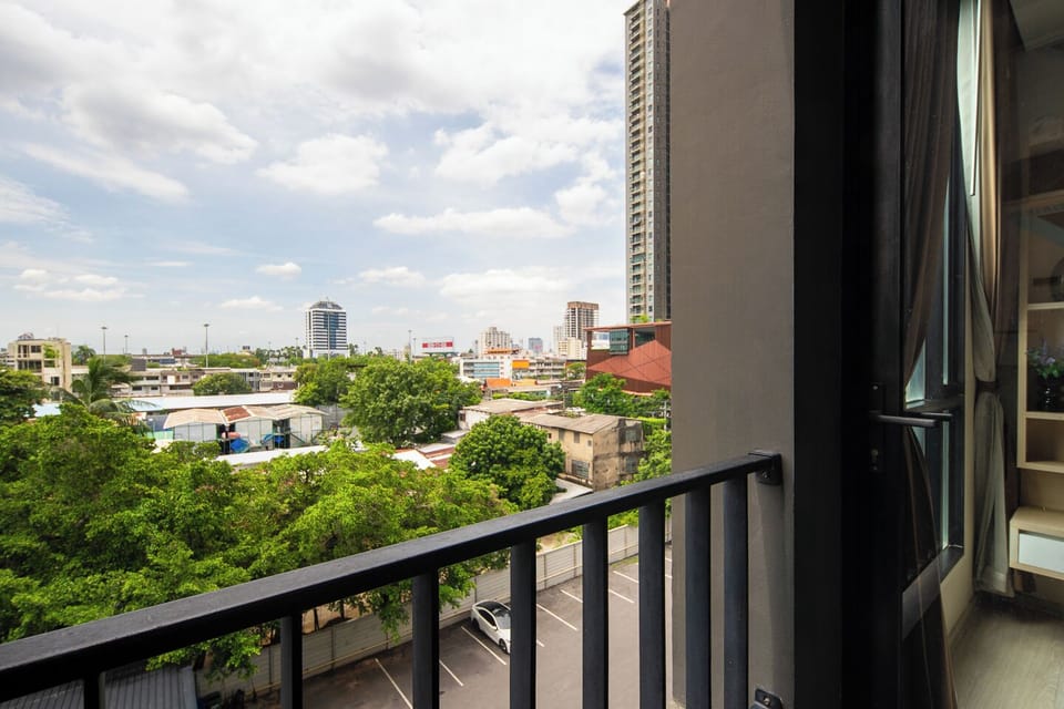 Private balcony with leafy city views and bright natural light