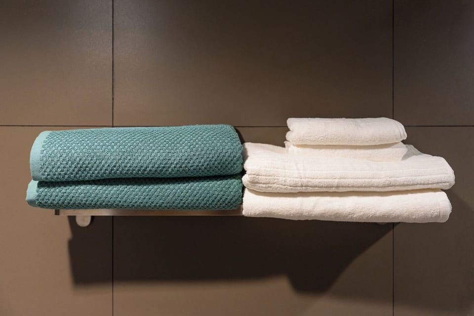 Fresh folded towels with a sleek, spa-like modern touch