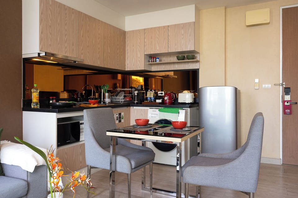 Modern kitchenette with dining for two and convenient in-room amenities