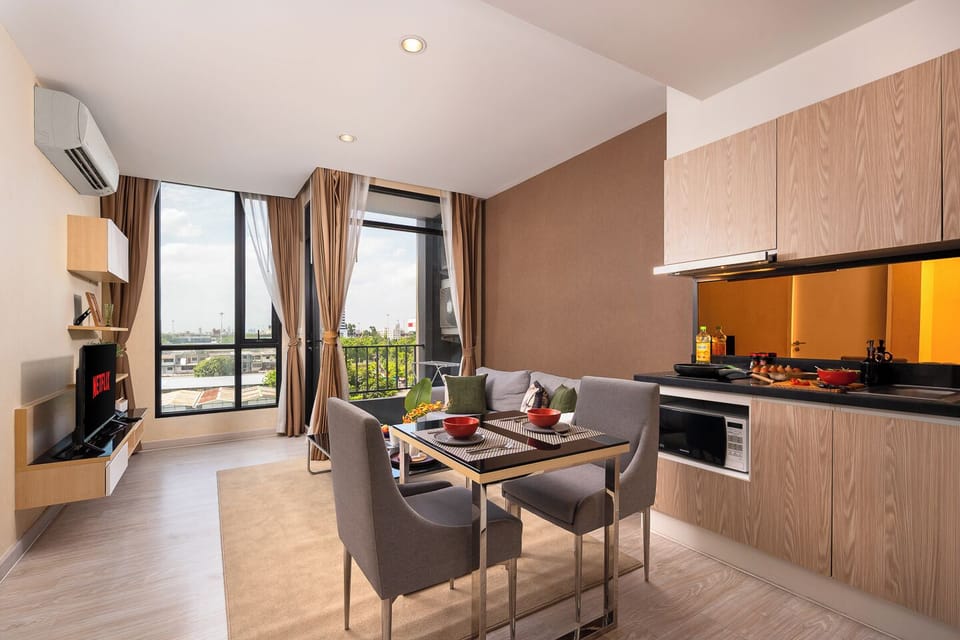 Bright modern apartment with balcony, dining area, and sleek kitchen