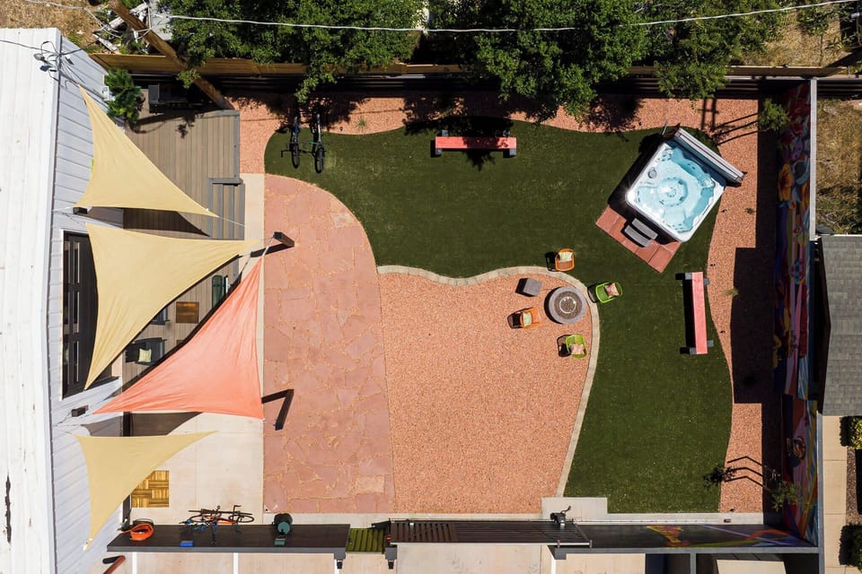 Experience ultimate relaxation and outdoor fun in the Bike Barn's backyard, featuring a hot tub, fire pit, and bike wash station!