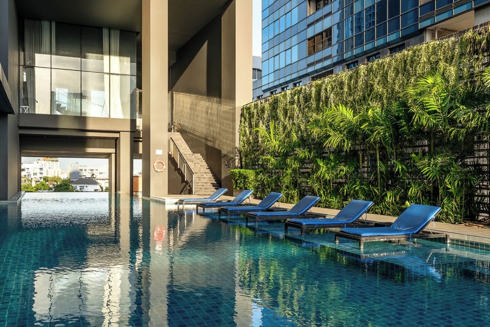 Resort-style pool with in-water loungers and lush tropical surroundings