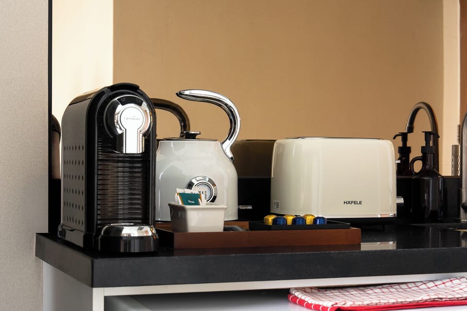 Modern coffee station with kettle, toaster, and pod machine