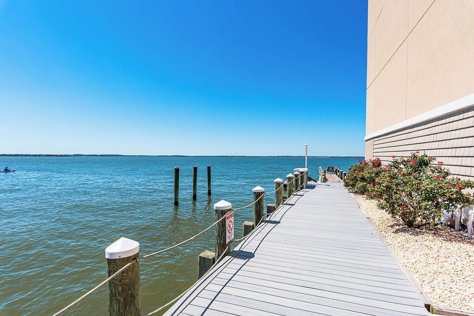 Tranquil bayside boardwalk with sweeping water views and dock access