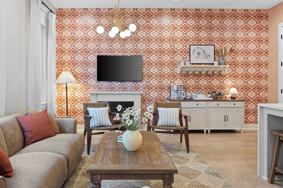 That wallpaper. The coffee station stocked and ready. The electric fireplace already on. This is what a good morning looks like. 