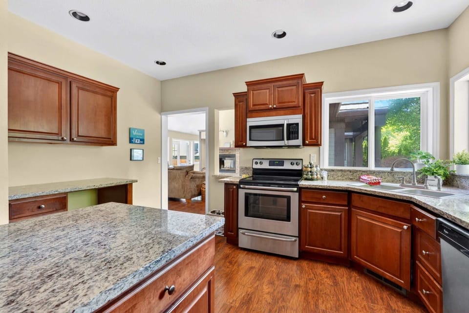 Kitchen with range, microwave, and window views.