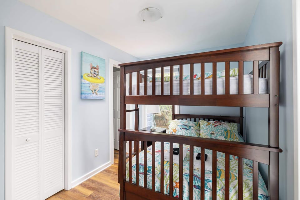 Lower level bunk room (full over full bunk) with a smart TV