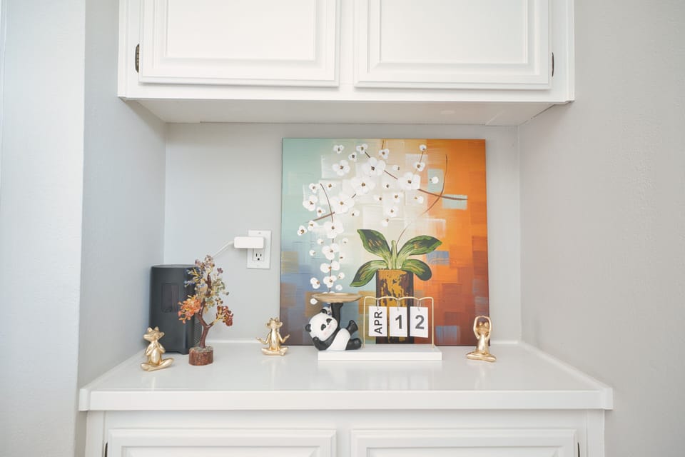 Cheerful built-in with art, coffee setup, and playful decor accents.