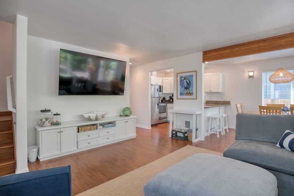 Relax and unwind in the cozy living area! Features a large flat-screen Smart TV, a media console packed with games on both sides, a big comfortable sectional, and easy access right into the kitchen.