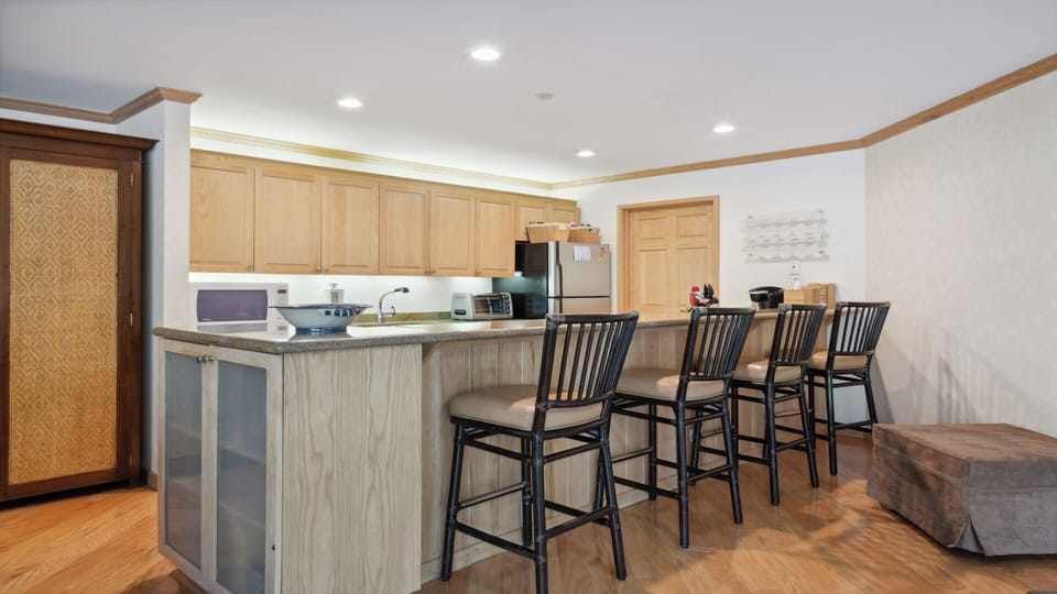 Gather around this spacious kitchen island with seating for four, where you can enjoy morning coffee or prepare meals with modern appliances at your fingertips.
