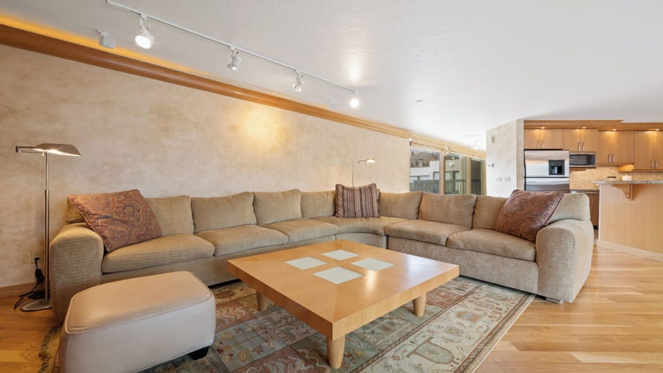 Settle into plush seating where warm lighting and open design flow seamlessly from lounge to kitchen, creating your perfect space to unwind after a day exploring.