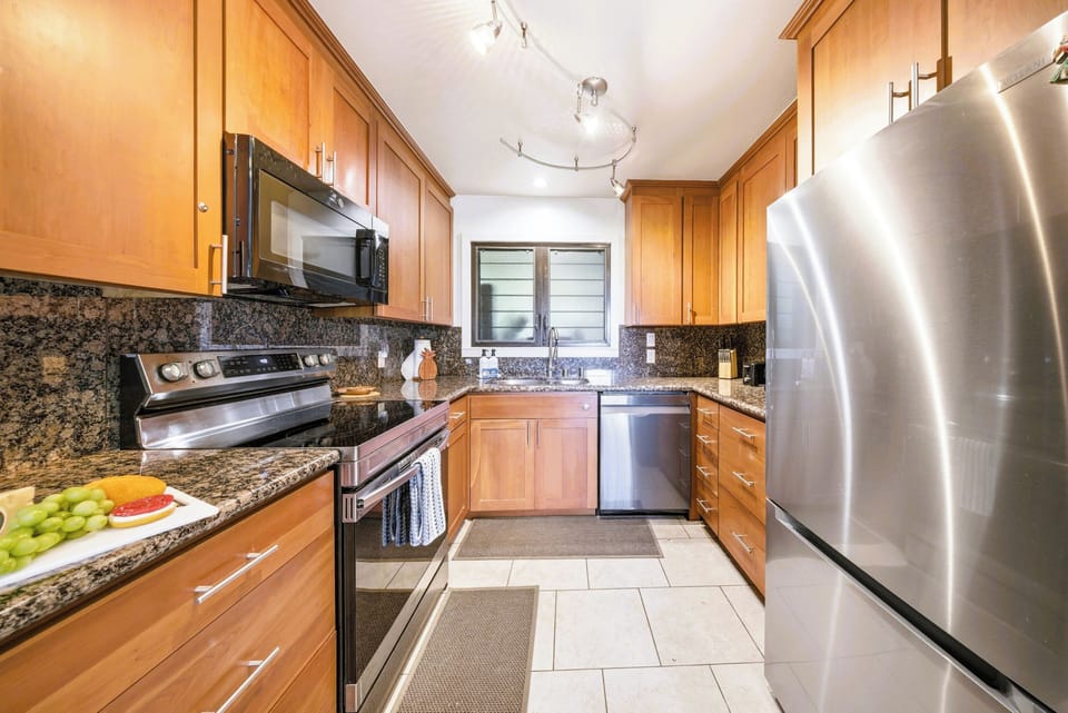 Full-size fridge, dishwasher, and granite — cook in like a local.