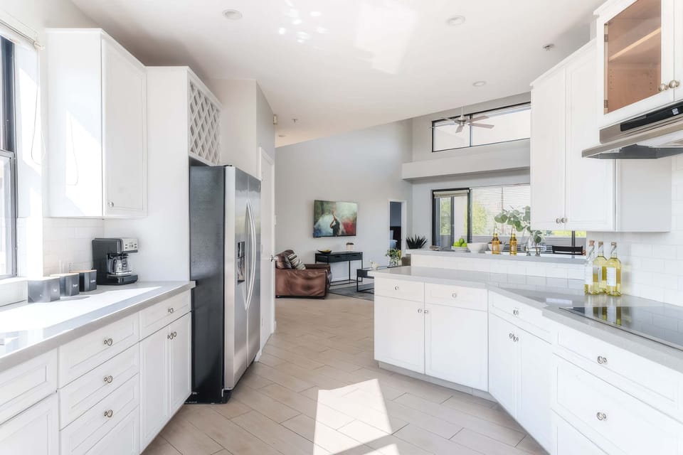 Sleek, well-equipped kitchen with stainless steel appliances, ample prep space, bar seating, and everything you need for meals, snacks, and easy entertaining.