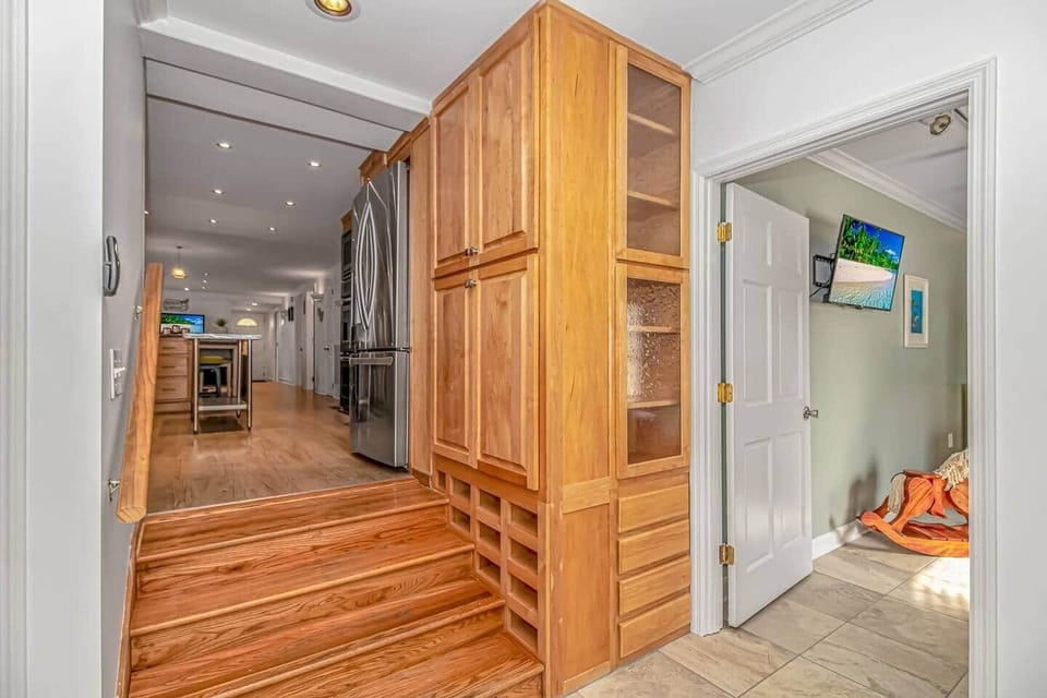 Open-concept layout with easy flow between the kitchen, living spaces & pool area