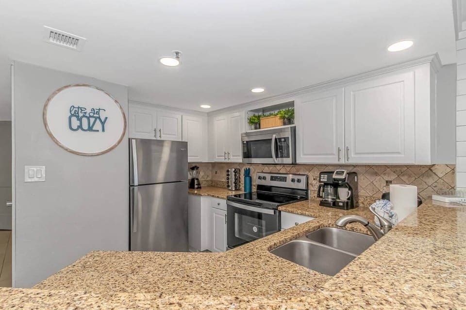 Modern Full Kitchen Featuring Granite Countertops & Bar Seating