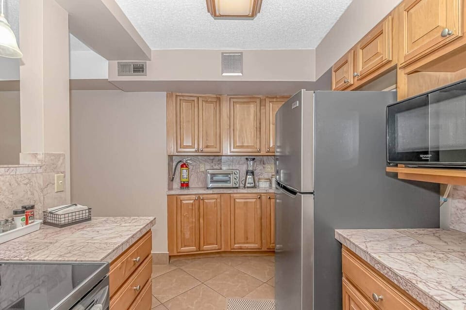 Fully stocked kitchen featuring granite countertops and stainless steel appliances 