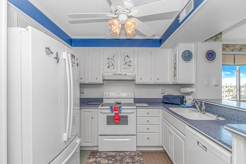 Bright full kitchen with ample counter space and appliances