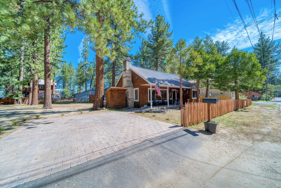 Another look at the exterior view, with trees, front porch, house exterior, and driveway.