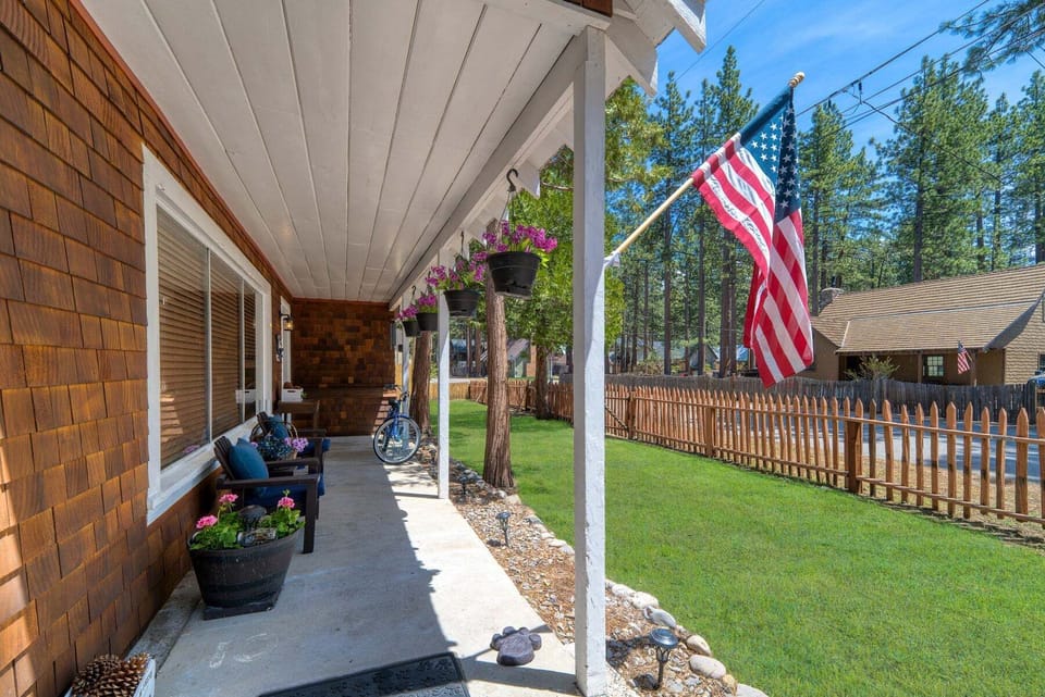 Front Porch includes front porch, covered porch, chairs, and hanging flower baskets.