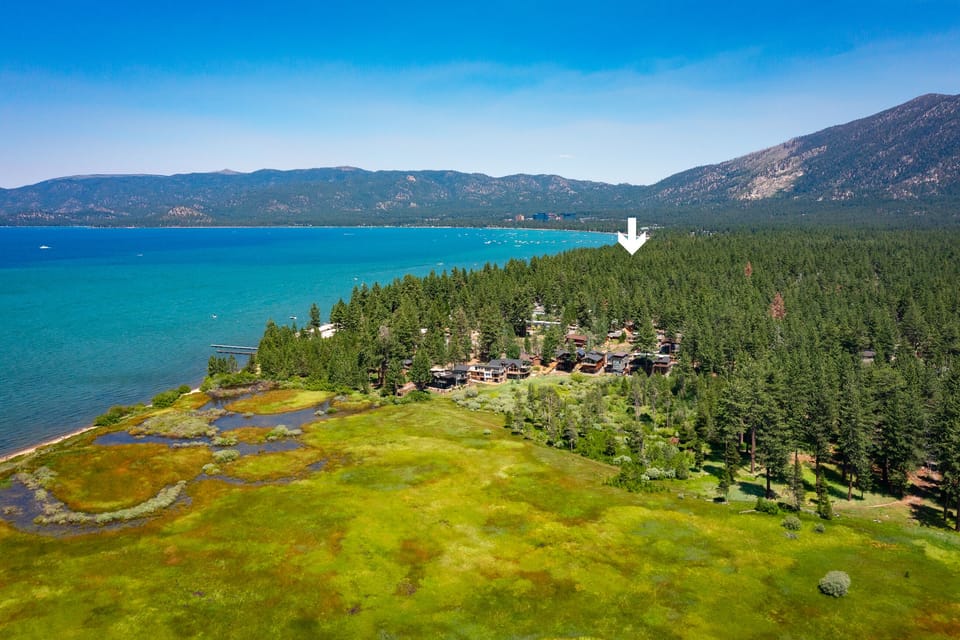 Another look at the exterior view, with lake, mountains, forest, and meadow.