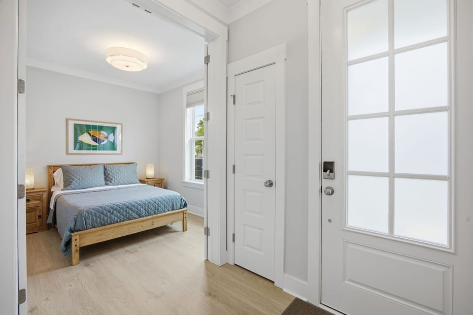 French doors open up to the downstairs bedroom with a Grain Wood full size bed and blackout shades. The French doors also have blackout curtains installed. This room does not have a closet in the room, but does have a closet just outside the door.