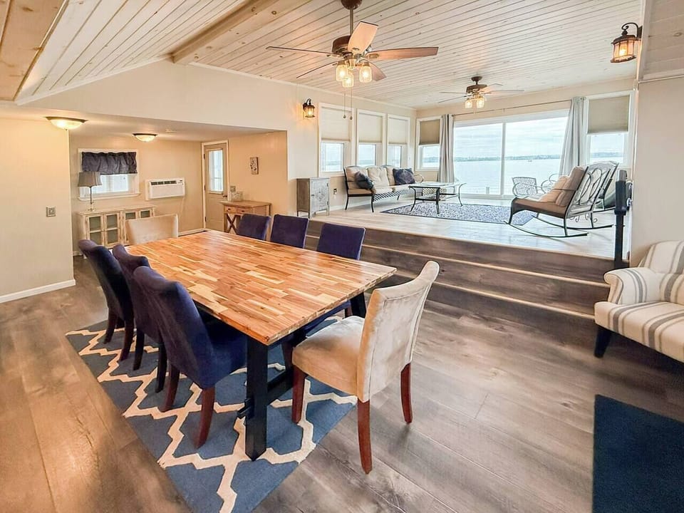 Gather around a butcher block table for 8, then step up to the lake-view sunroom for after-dinner chairs and Cayuga sunsets. Cozy, open, and made for families.