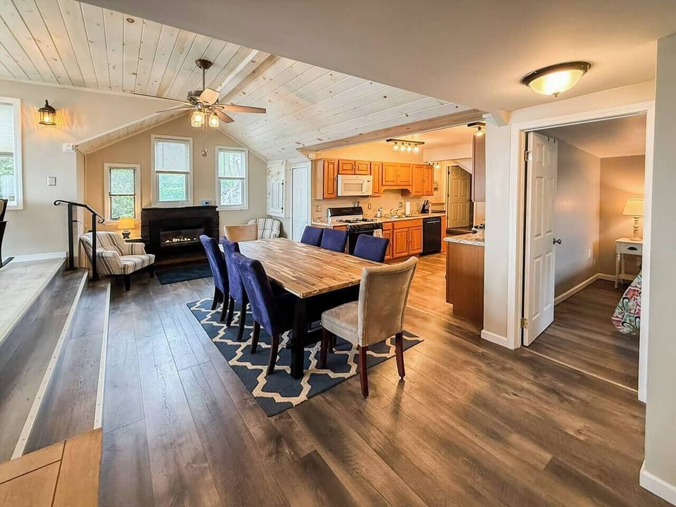 Open-concept main floor with a gas fireplace, dining for 8, and a full kitchen — everything a family needs after a long day on the lake, all in one warm, vaulted space.