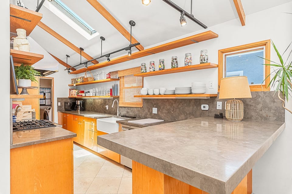 Expansive kitchen peninsula offers ample space for meal prep, serving, and gathering
                