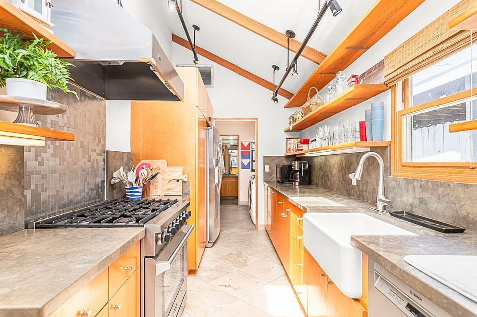 Cook and connect in the spacious gourmet kitchen with stone countertops throughout
                
