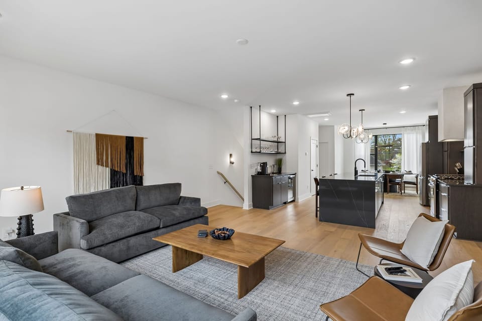 Living Room: A bright living room with large windows, spacious sofas, and a TV for relaxing entertainment.