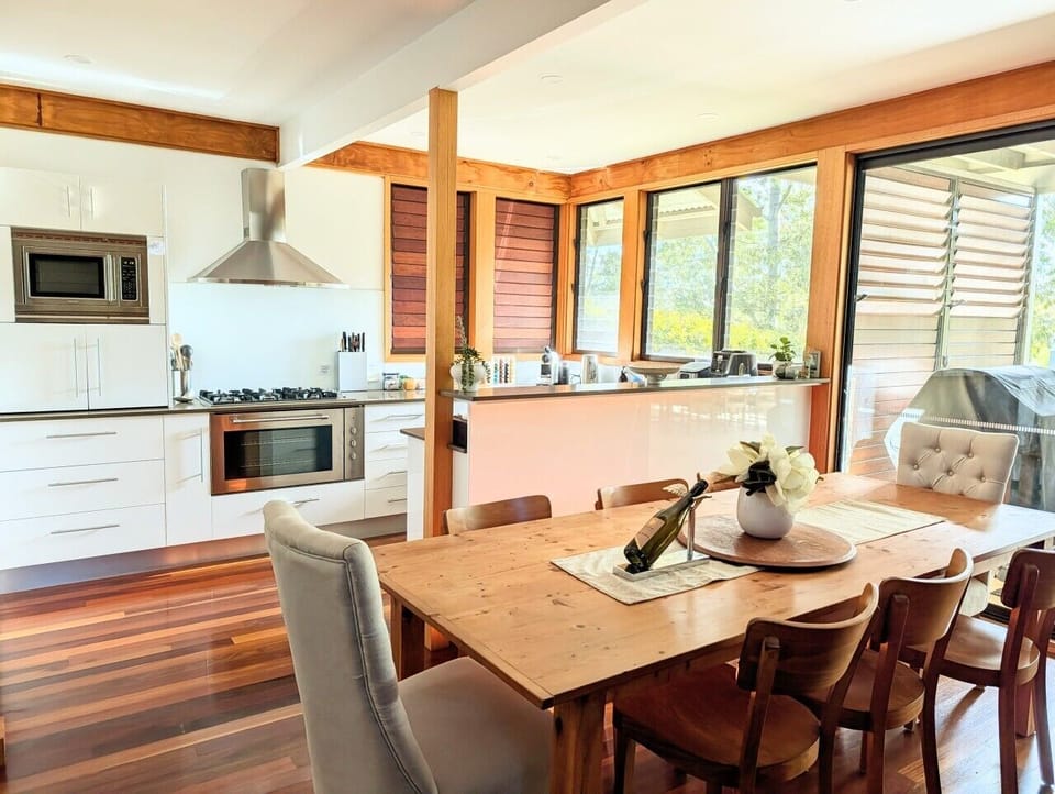 Open kitchen with gas cooktop, electric oven, Nespresso machine, ice maker and air fryer. Stocked with tea, coffee and more. Direct access to the front balcony with BBQ. Everything needed for a relaxed group stay.
