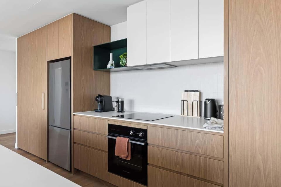 Modern, fully equipped kitchen with quality appliances and generous bench space — ideal for cooking, casual meals or morning coffee.