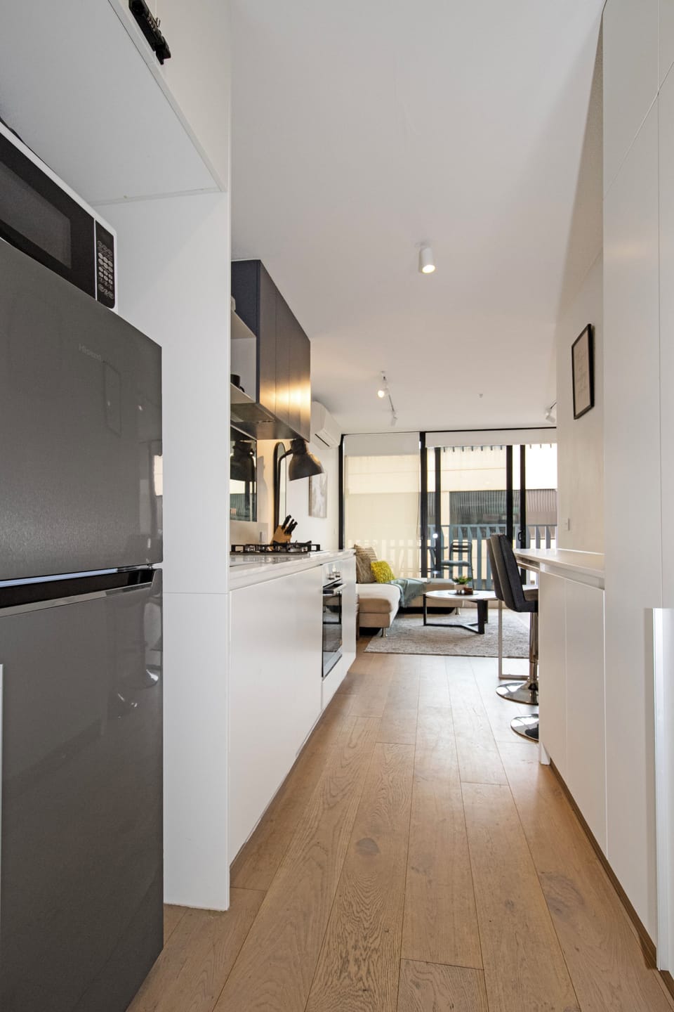 Bright modern kitchen with open-plan living and balcony access