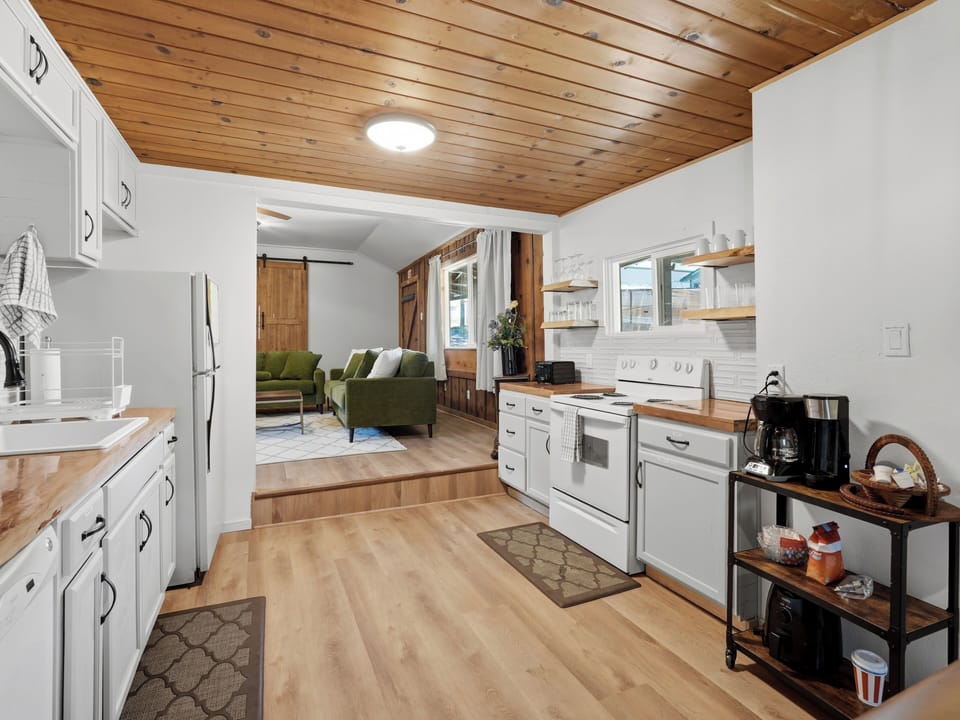 Cozy open kitchen with wood ceilings and easy flow to the living room