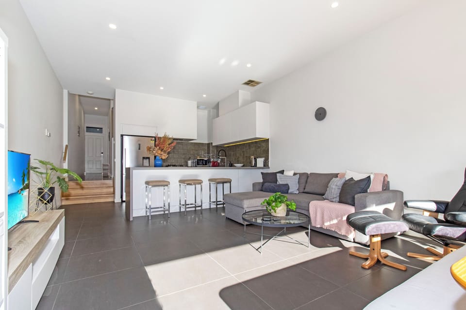Bright open-plan living with stylish kitchen, breakfast bar, and cozy lounge