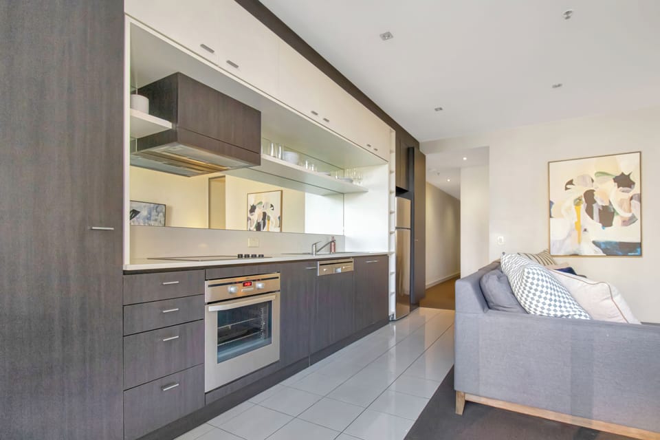 Modern open-plan kitchen and lounge with sleek finishes and cozy seating