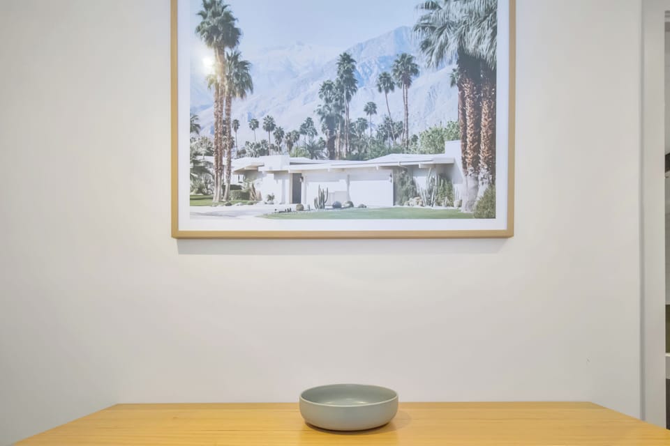 Minimalist entry styling with desert-inspired artwork and modern warmth